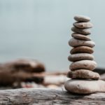 rock-stack-on-log-by-water_4460x4460
